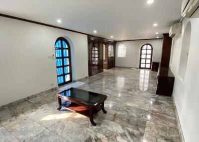 Spacious living room with marble floor and arched windows