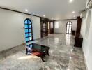 Spacious living room with marble floor and arched windows