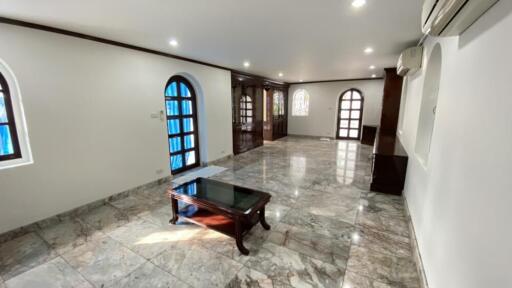 Spacious living room with marble floor and arched windows