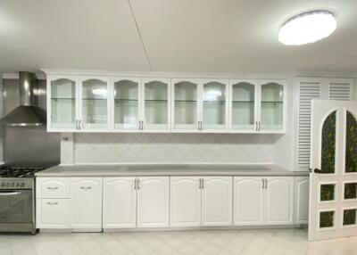 Spacious kitchen with modern appliances and white cabinetry