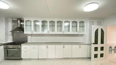 Spacious kitchen with modern appliances and white cabinetry