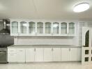 Spacious kitchen with modern appliances and white cabinetry