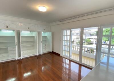 Spacious bedroom with built-in wardrobes and large windows