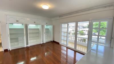 Spacious bedroom with built-in wardrobes and large windows