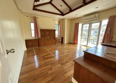 Spacious living room with wooden flooring and large windows