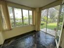 Sunroom with tiled floor and garden view