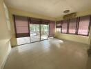 Bright living room with large windows and air conditioning unit.