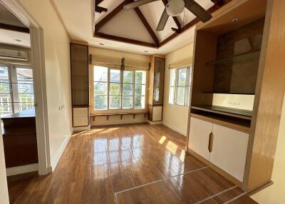 Spacious living room with wooden floors and large windows