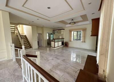 Spacious living room with polished floors and large windows