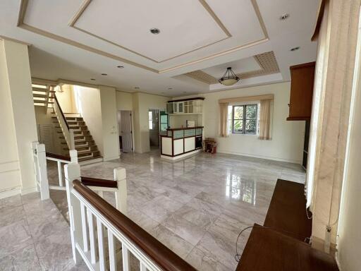 Spacious living room with polished floors and large windows