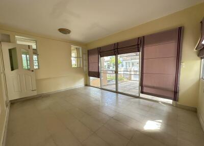 Spacious living room with large windows and sliding glass door