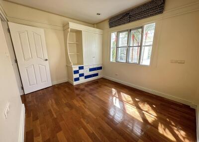 Bedroom with hardwood floors and built-in storage