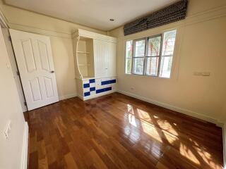 Bedroom with hardwood floors and built-in storage