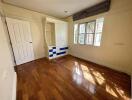 Bedroom with hardwood floors and built-in storage