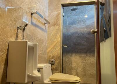 Modern bathroom with glass-enclosed shower and toilet