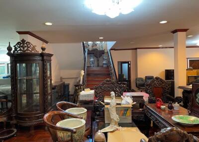 Living room with traditional wooden furniture and a staircase