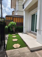 Front yard with stepping stones and small tree