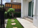 Front yard with stepping stones and small tree