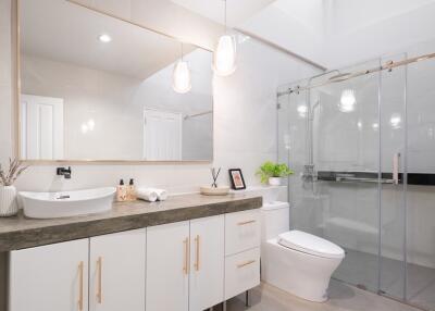 Modern bathroom with large mirror, vanity, and glass shower