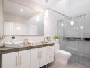 Modern bathroom with large mirror, vanity, and glass shower