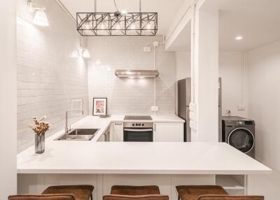 Modern kitchen with island counter and bar stools