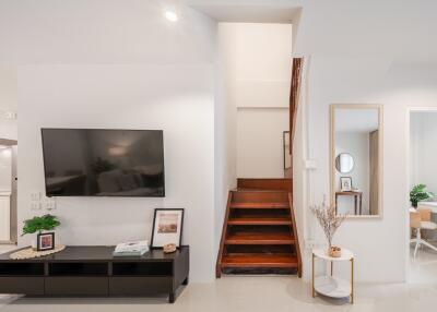 Modern living area with TV and staircase