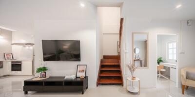 Modern living area with TV and staircase