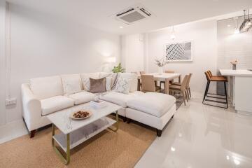 Modern living room with dining area and a small kitchen