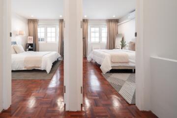 Double bedroom setup with modern decor and hardwood floors