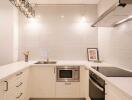 Modern kitchen with white cabinetry and built-in appliances