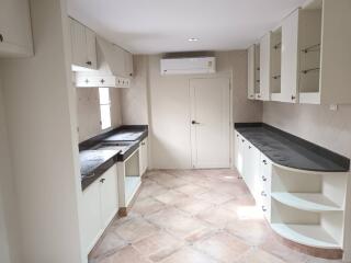 Modern kitchen with white cabinetry and marble countertops