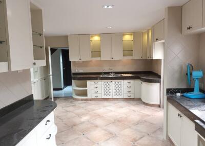 Spacious kitchen with modern cabinets and large countertops