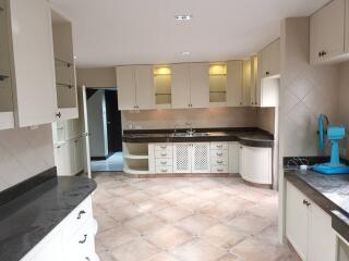 Spacious kitchen with modern cabinets and large countertops