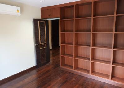 Empty room with wooden shelves and open doorway