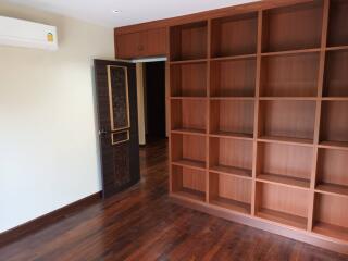 Empty room with wooden shelves and open doorway