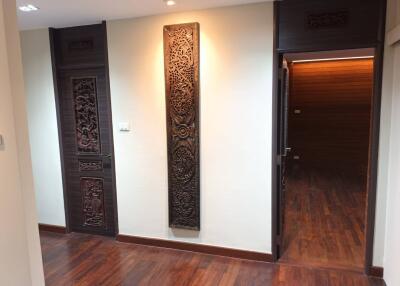 hallway with wooden doors and decorative panels