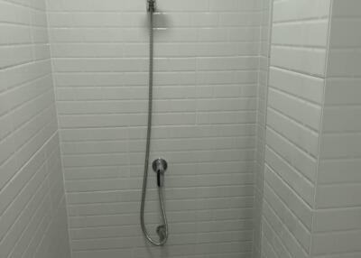 Shower area with white tiling