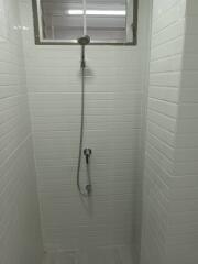 Shower area with white tiling