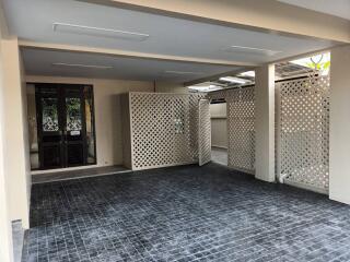 Spacious covered garage with lattice fencing