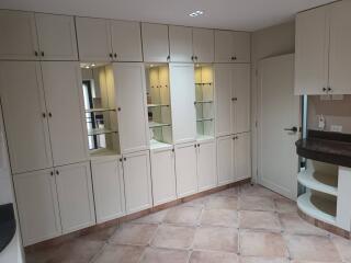 Spacious kitchen with ample cabinetry and built-in shelving