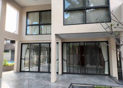 Modern double-story building with large glass windows and sliding doors