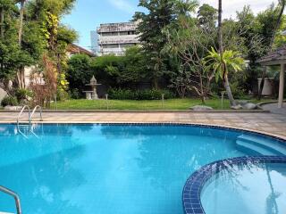 Outdoor swimming pool area with residential background