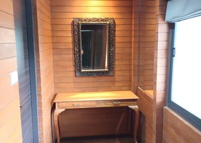 Cozy bedroom corner with wooden panel walls and a dressing table