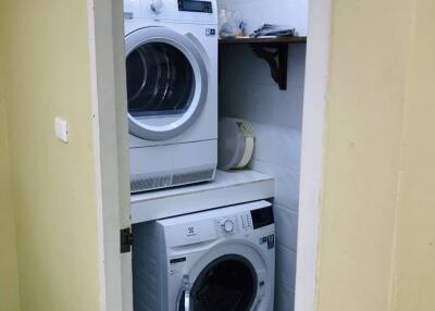 Laundry room with stacked washer and dryer