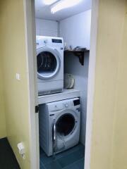 Laundry room with stacked washer and dryer