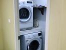 Laundry room with stacked washer and dryer