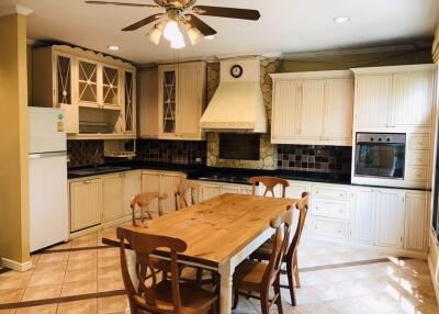 Spacious Kitchen with Wooden Cabinets and Dining Table