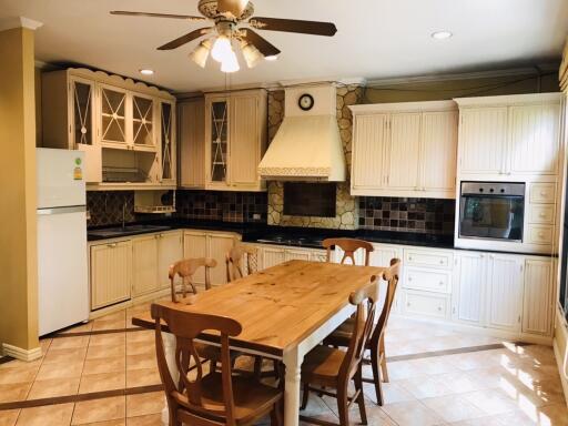 Spacious Kitchen with Wooden Cabinets and Dining Table