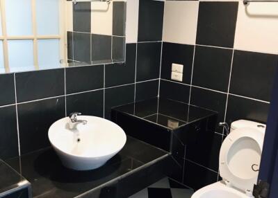 Bathroom with black and white checkered tiles