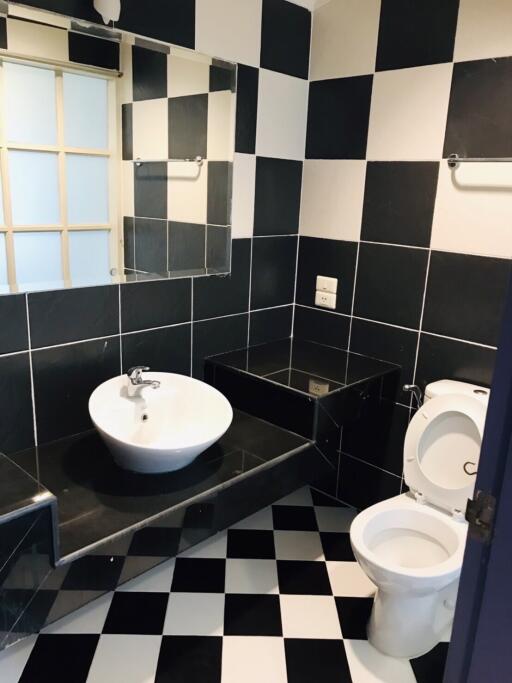 Bathroom with black and white checkered tiles